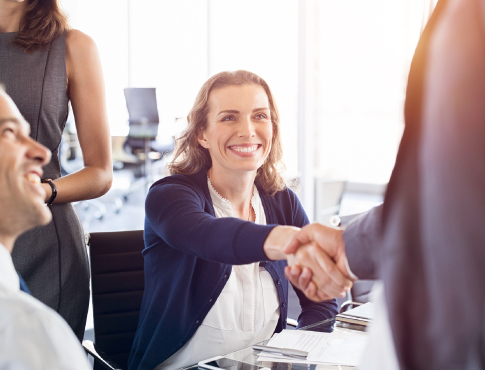 Woman shaking hands with another businessperson