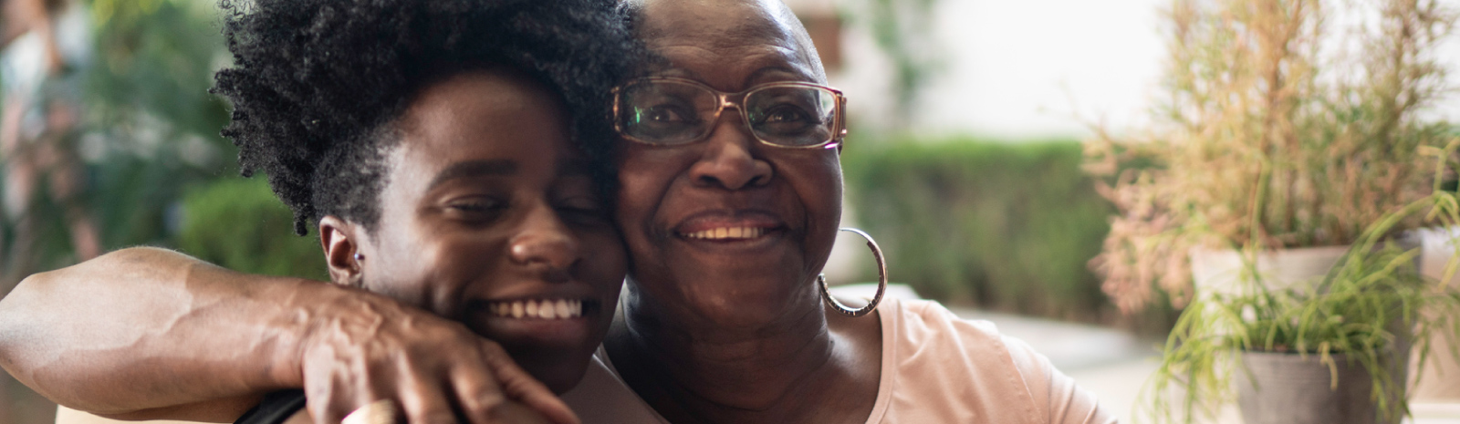 Two woman hugging and smiling