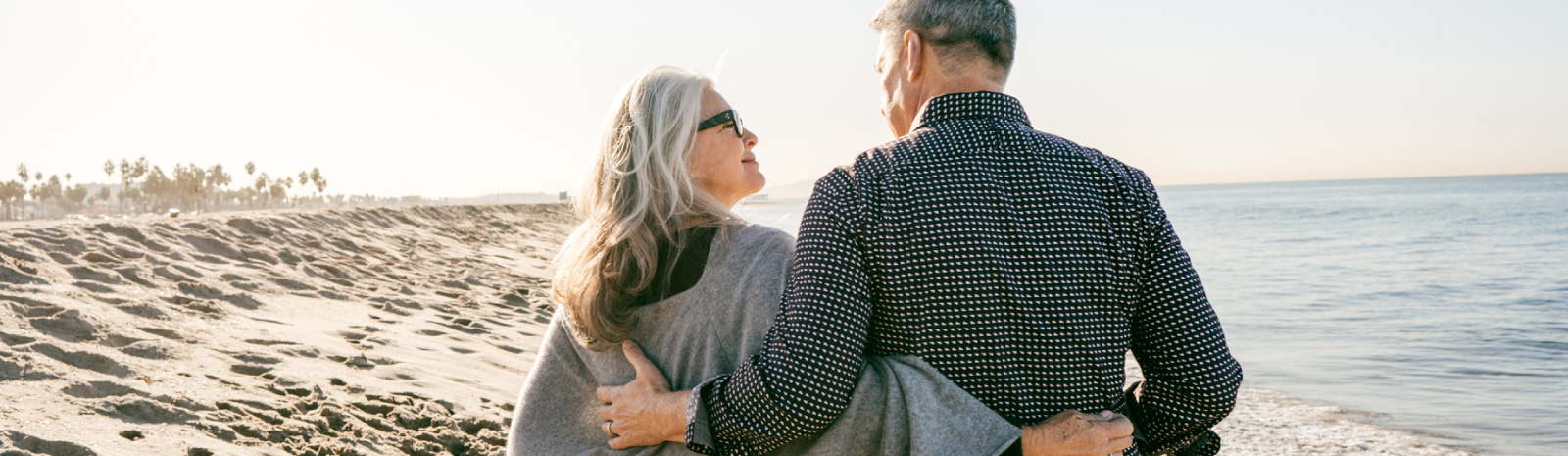 mature couple walking on beach